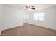 Bright, carpeted bedroom with two windows and a ceiling fan providing fresh air at 134 E Bernie Ln, Gilbert, AZ 85295