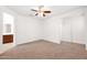 Spacious carpeted bedroom featuring access to a walk-in closet and a bathroom at 134 E Bernie Ln, Gilbert, AZ 85295