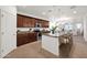 Open concept kitchen with dark wood cabinets, granite countertops and a large island at 134 E Bernie Ln, Gilbert, AZ 85295