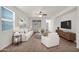Bright and airy living room with white furniture, ceiling fan, and modern decor at 134 E Bernie Ln, Gilbert, AZ 85295