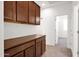 A spacious mudroom features dark wood cabinets and ample counter space, leading to a bedroom at 134 E Bernie Ln, Gilbert, AZ 85295
