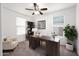 Bright office space with desk, chair, ceiling fan, bookcase and plants at 134 E Bernie Ln, Gilbert, AZ 85295