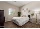 Cozy bedroom with a queen bed, large window, and decorative accents at 1367 S Country Club Dr # 1039, Mesa, AZ 85210
