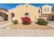 Two-story home featuring charming architecture, a red flower bush and a two car garage at 1367 S Country Club Dr # 1039, Mesa, AZ 85210