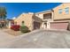 Lovely, two-story house featuring a private balcony, two car garage and a red flower bush at 1367 S Country Club Dr # 1039, Mesa, AZ 85210