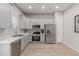 Bright kitchen features grey cabinets, stainless steel appliances and wood-look tile at 1367 S Country Club Dr # 1039, Mesa, AZ 85210