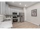 Well-lit kitchen offers grey cabinets, stainless steel appliances, and wood-look tile flooring at 1367 S Country Club Dr # 1039, Mesa, AZ 85210