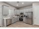 Well-lit kitchen features modern gray cabinets, stainless steel appliances, and wood-look tile floors at 1367 S Country Club Dr # 1039, Mesa, AZ 85210