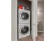 Compact laundry closet featuring a stacked washer and dryer set for convenient laundry solutions at 1367 S Country Club Dr # 1039, Mesa, AZ 85210