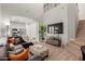 Spacious living room featuring tile floors, stairs, large TV and a seamless transition to an open-concept kitchen at 1367 S Country Club Dr # 1039, Mesa, AZ 85210