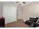 Comfortable living room with a black leather sofa, neutral walls, and closet at 1367 S Country Club Dr # 1039, Mesa, AZ 85210