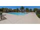 Large community pool with palm trees and lounge chairs on a sunny day at 1367 S Country Club Dr # 1039, Mesa, AZ 85210