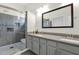 Bathroom featuring double sinks, gray cabinetry and a tiled shower at 14415 N 184Th Ave, Surprise, AZ 85388