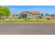 Charming single-story home features a desert landscape, lush lawn and a welcoming facade at 14415 N 184Th Ave, Surprise, AZ 85388