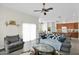 Open-concept living room with tile floors, flowing into the kitchen and dining area at 14415 N 184Th Ave, Surprise, AZ 85388