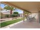 Covered patio overlooking a well-kept backyard with grass, rock, and artificial turf at 16205 W Mountain Pass Dr, Surprise, AZ 85374