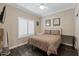 Bedroom with hardwood floors, plantation shutters, ceiling fan, and two mirrors at 16205 W Mountain Pass Dr, Surprise, AZ 85374