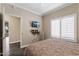 Bedroom featuring hardwood floors, TV, and view to the next room at 16205 W Mountain Pass Dr, Surprise, AZ 85374