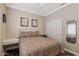 Bedroom with hardwood floors, closet with sliding door, and small workspace at 16205 W Mountain Pass Dr, Surprise, AZ 85374