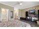 Bedroom showcases neutral walls, walk-in closet, ensuite bathroom, and entertainment center at 16205 W Mountain Pass Dr, Surprise, AZ 85374