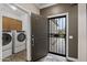 Home entryway featuring a security door, view of the laundry room, and an open concept design at 16205 W Mountain Pass Dr, Surprise, AZ 85374