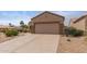 Charming home exterior with well-maintained landscaping, a spacious driveway, and a two-car garage, showcasing curb appeal at 16205 W Mountain Pass Dr, Surprise, AZ 85374