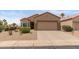Single story home with desert landscaping, two-car garage, and well-kept facade at 16205 W Mountain Pass Dr, Surprise, AZ 85374