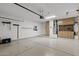 Large garage with epoxy flooring, custom storage solutions, and a dedicated workspace, perfect for projects and organization at 16205 W Mountain Pass Dr, Surprise, AZ 85374