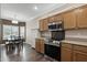 Charming eat-in kitchen with stainless steel appliances and adjacent dining area with natural light at 16205 W Mountain Pass Dr, Surprise, AZ 85374