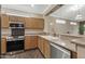 Bright kitchen featuring stainless steel appliances, light wood cabinets, and granite countertops at 16205 W Mountain Pass Dr, Surprise, AZ 85374