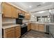 Well-lit kitchen featuring wood cabinets, stainless steel appliances, and modern finishes at 16205 W Mountain Pass Dr, Surprise, AZ 85374
