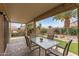 Covered patio with outdoor dining furniture overlooking the backyard at 16205 W Mountain Pass Dr, Surprise, AZ 85374