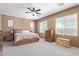 Bright and airy bedroom with a king-size bed, plush carpeting, and ample natural light from multiple windows at 16987 W Hammond St, Goodyear, AZ 85338