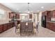 Inviting dining area featuring dark wood cabinetry, countertops, and seating for four at a bright, modern table at 16987 W Hammond St, Goodyear, AZ 85338