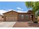 Charming single-story home featuring a stone facade, two-car garage, and well-maintained landscaping at 16987 W Hammond St, Goodyear, AZ 85338