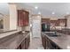 Spacious kitchen features granite counters, stainless appliances, tiled floors, and easy access to the dining area at 16987 W Hammond St, Goodyear, AZ 85338