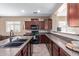 Stylish kitchen with granite counters, stainless steel appliances, tiled floors, and plenty of cabinet storage at 16987 W Hammond St, Goodyear, AZ 85338