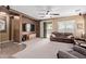 Inviting living room featuring neutral carpet, ceiling fan, and sliding doors to the backyard at 16987 W Hammond St, Goodyear, AZ 85338