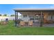 Spacious backyard featuring a covered patio with outdoor seating and a fire pit at 1702 W Glenrosa Ave, Phoenix, AZ 85015