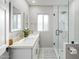 Bright bathroom featuring a double vanity, glass shower, and modern fixtures at 1702 W Glenrosa Ave, Phoenix, AZ 85015