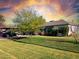 Charming single-story home featuring a well-maintained lawn and mature tree, offering a welcoming curb appeal at 1702 W Glenrosa Ave, Phoenix, AZ 85015