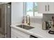 Bright kitchen featuring stainless steel appliances, a gold faucet, and white cabinets with quartz countertops at 1702 W Glenrosa Ave, Phoenix, AZ 85015
