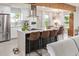Open kitchen featuring a large island with seating, stainless steel appliances, and modern light fixtures at 1702 W Glenrosa Ave, Phoenix, AZ 85015