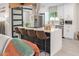 Modern kitchen featuring a sleek island with seating, stainless steel appliances, perfect for casual dining and entertaining at 1702 W Glenrosa Ave, Phoenix, AZ 85015