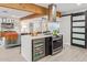 Open kitchen featuring a wine refrigerator, stainless steel stove and hood, and a quartz countertop island at 1702 W Glenrosa Ave, Phoenix, AZ 85015