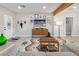 Stylish living room showcasing a modern media center, wood beam, and eclectic decor against a neutral backdrop at 1702 W Glenrosa Ave, Phoenix, AZ 85015