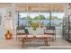 Modern living room with floor-to-ceiling windows and view to backyard pool at 1702 W Glenrosa Ave, Phoenix, AZ 85015