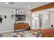 Bright living room with a gallery wall, modern wood storage, and light-colored floors at 1702 W Glenrosa Ave, Phoenix, AZ 85015