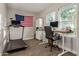 Bright office space with treadmill, large windows, and a sleek desk setup at 1702 W Glenrosa Ave, Phoenix, AZ 85015