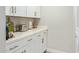 Pantry featuring white cabinetry, quartz countertops, and stainless steel appliances at 1702 W Glenrosa Ave, Phoenix, AZ 85015